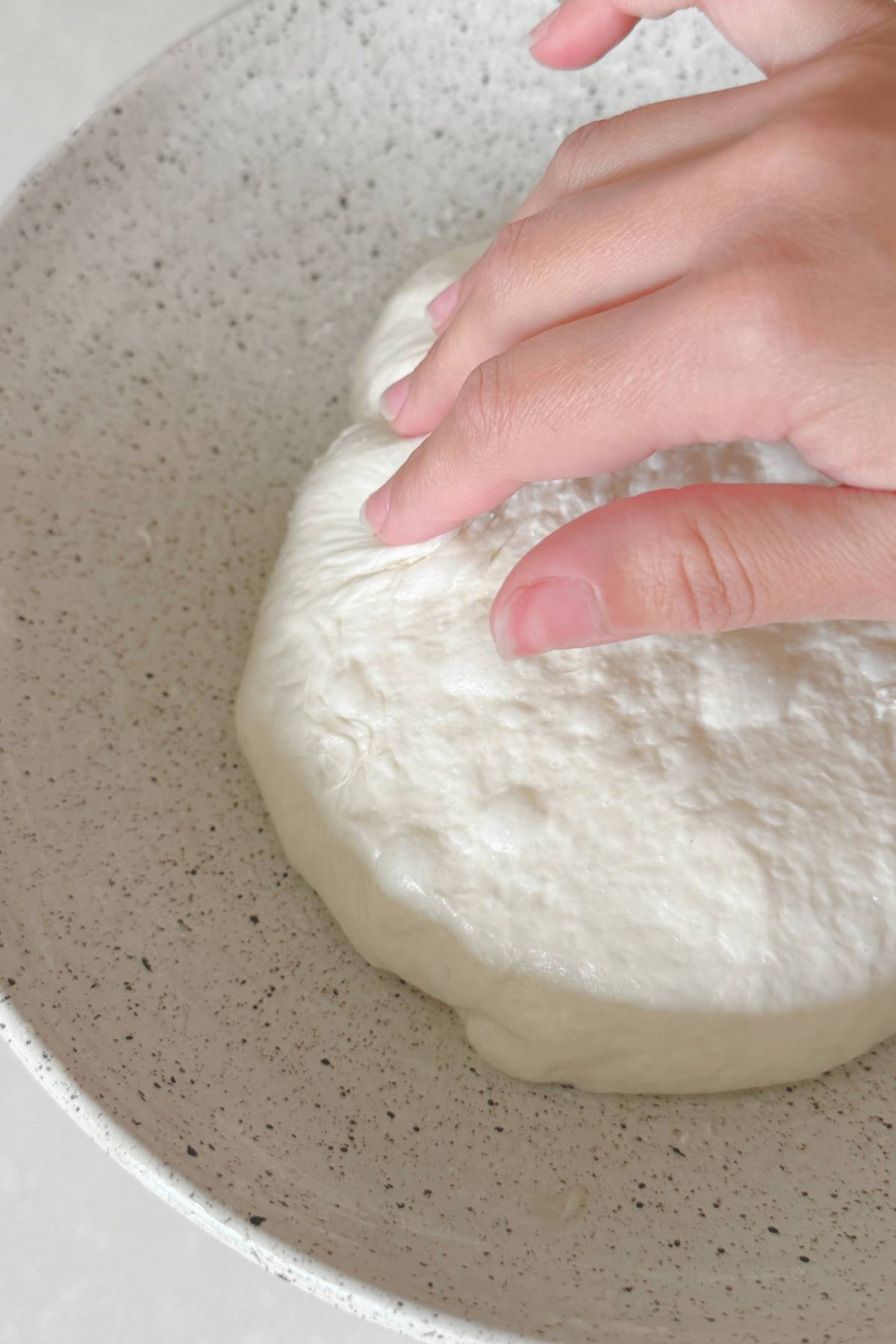 Dough pulling away from sides of bowl