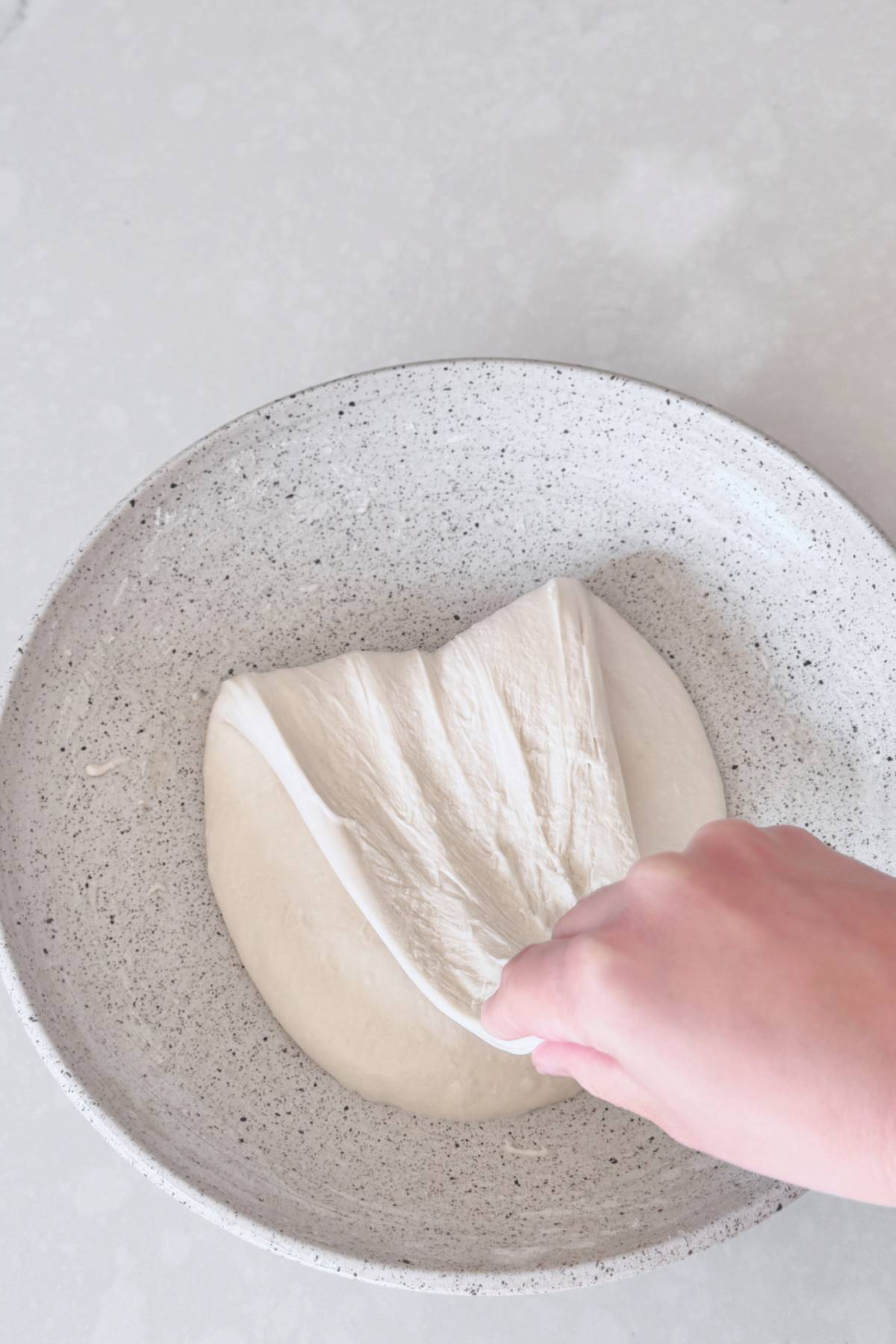 folding the dough down and over itself
