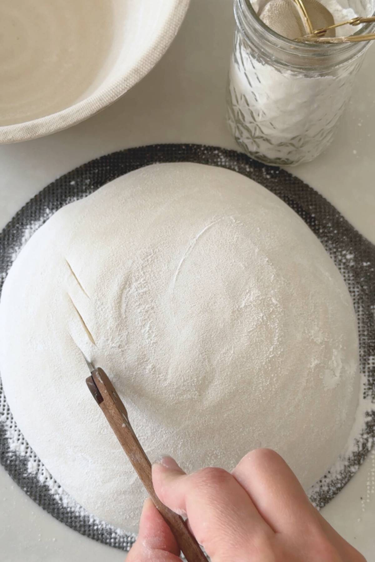 using a lame to make small, shallow decorative scores