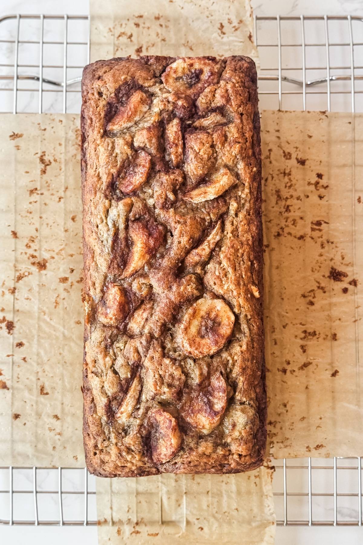 loaf of moist banana bread on a cooling rack