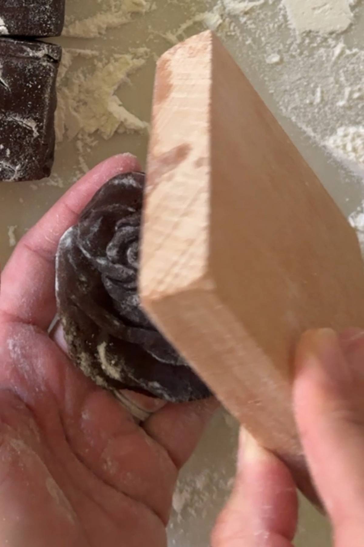 releasing the cookie from the wooden mold