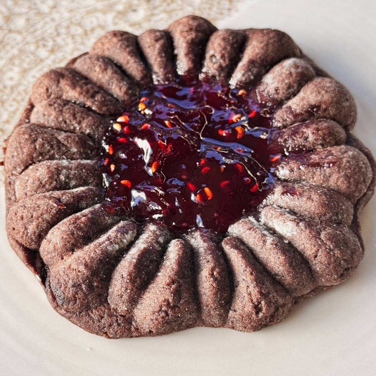 chocolate molded cookie with jam in the middle