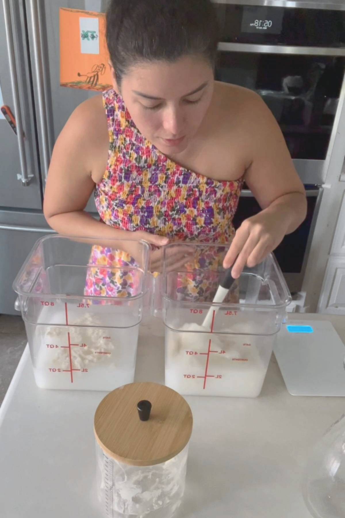 Maria Baradell mixing sourdough starter in bulk