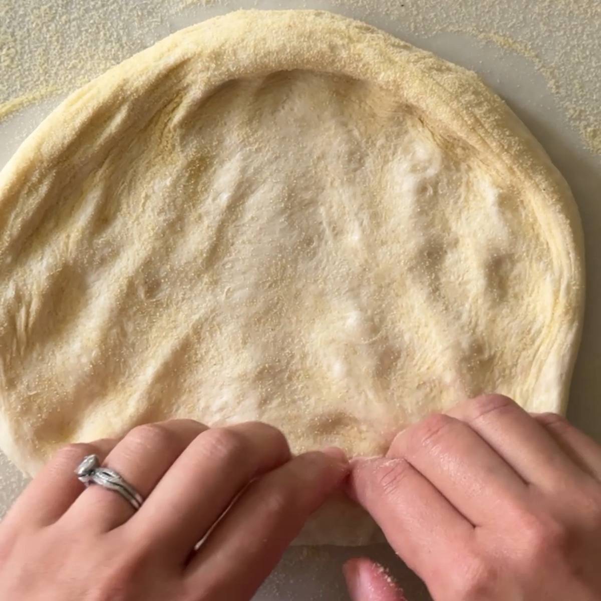 shaping pizza crust
