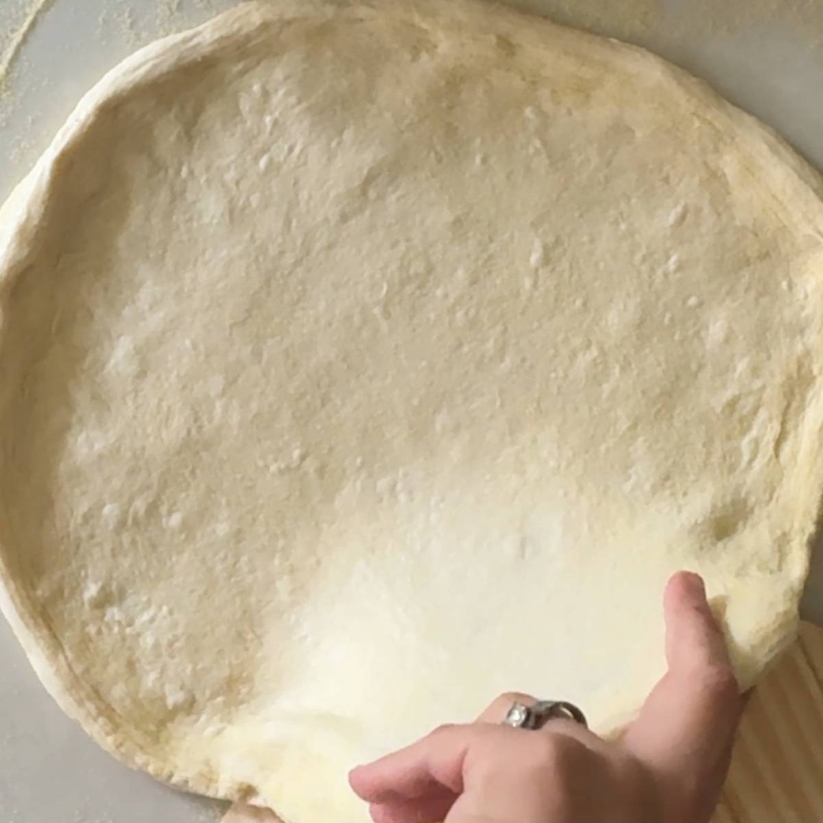 transfering pizza dough to pizza peel