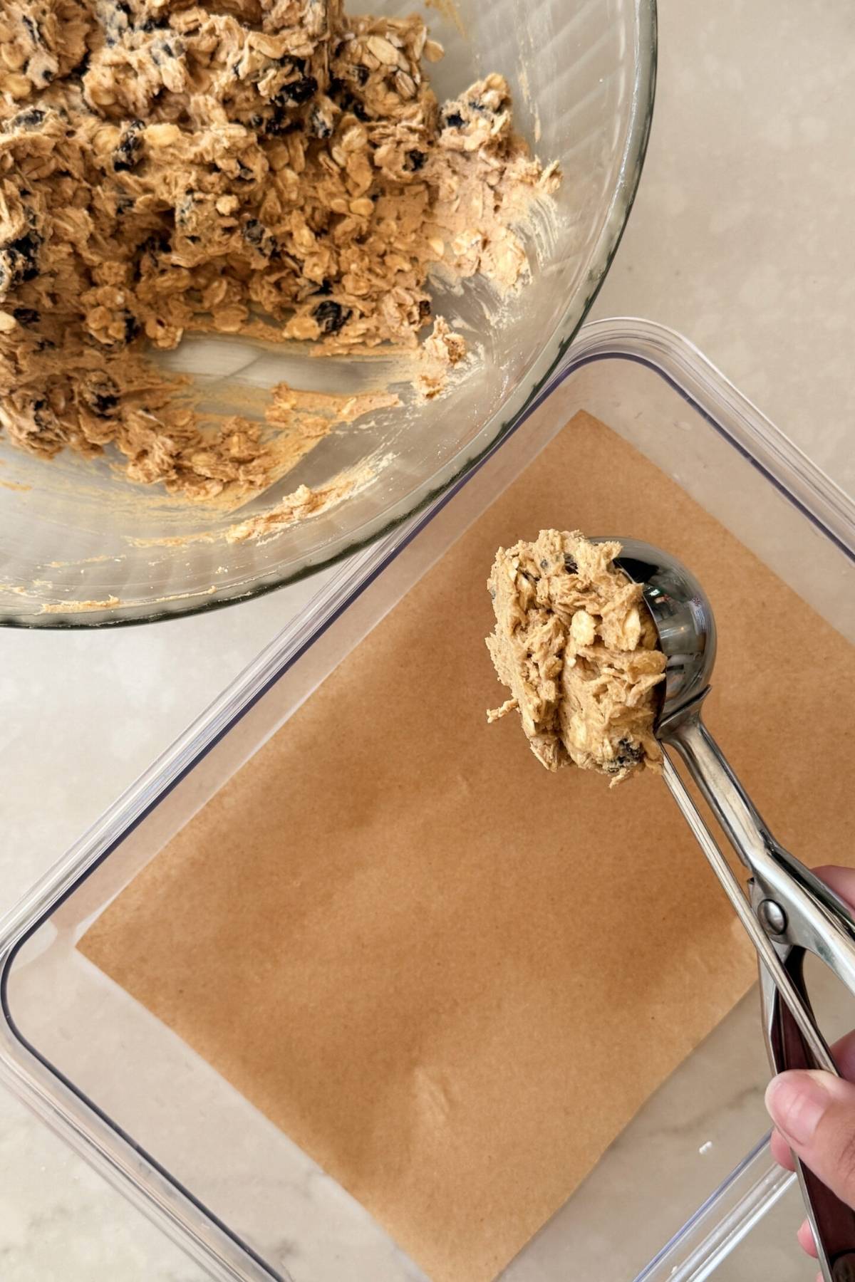 scooping oatmeal raisin cookie dough