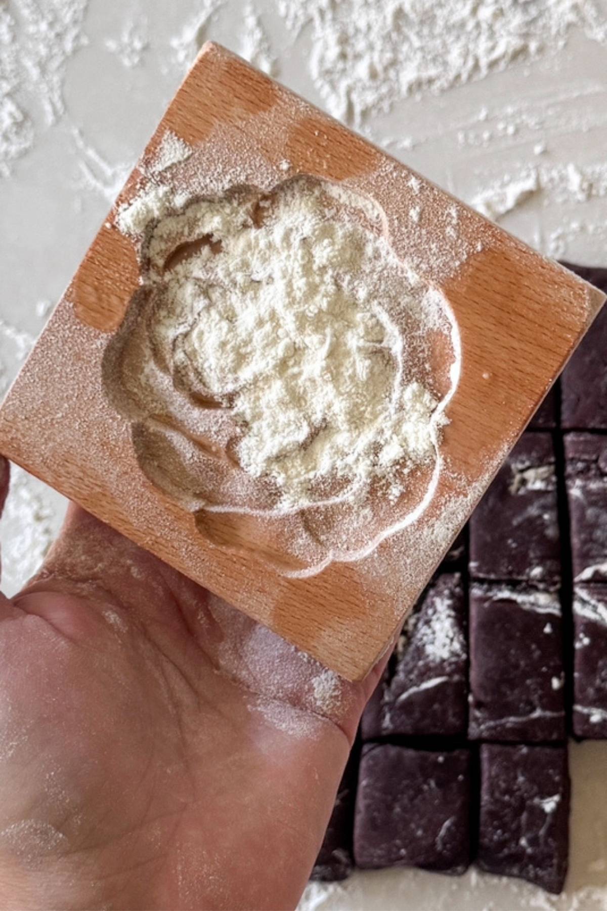 flour on the wooden cookie mold