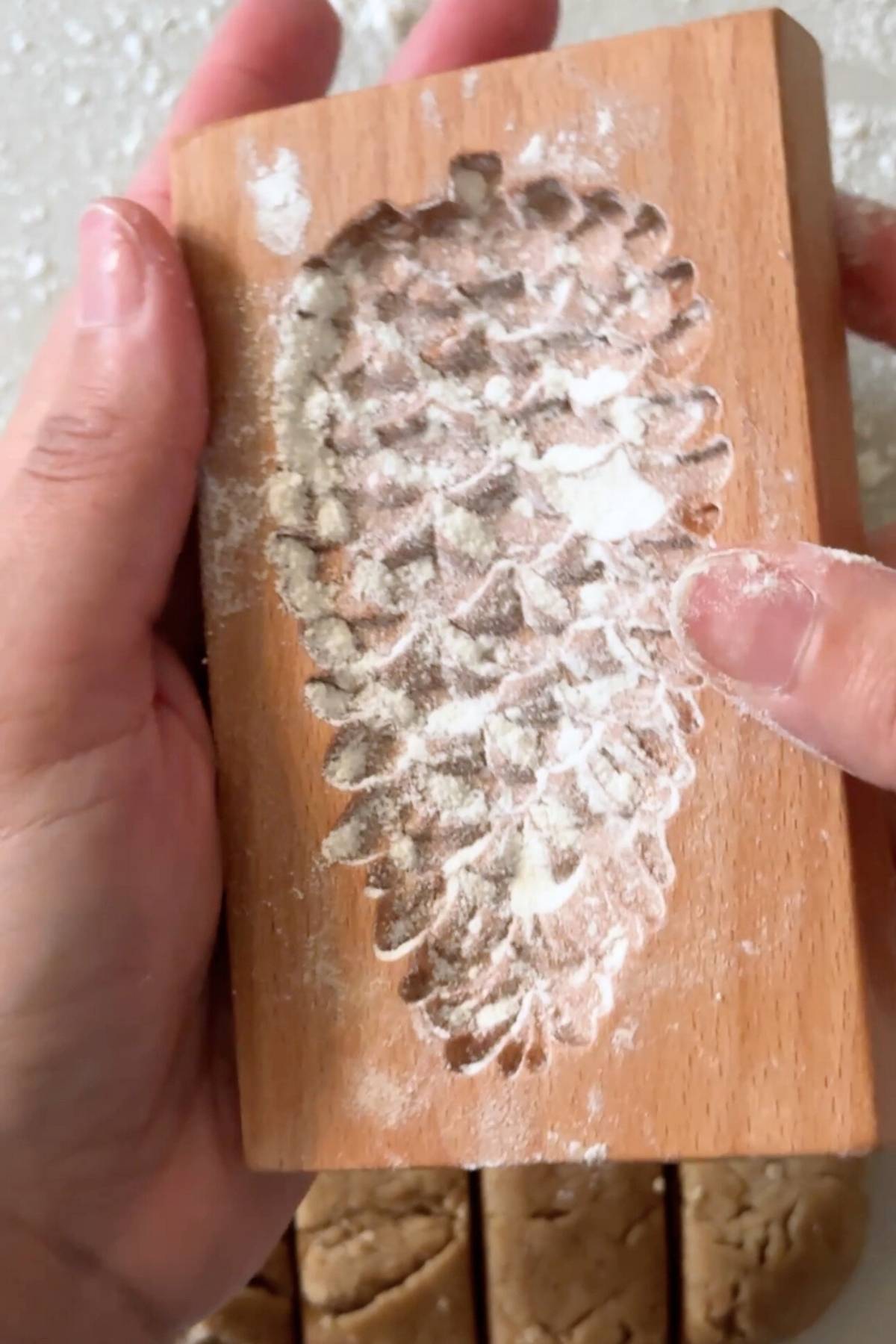 dusting flour on cookie mold