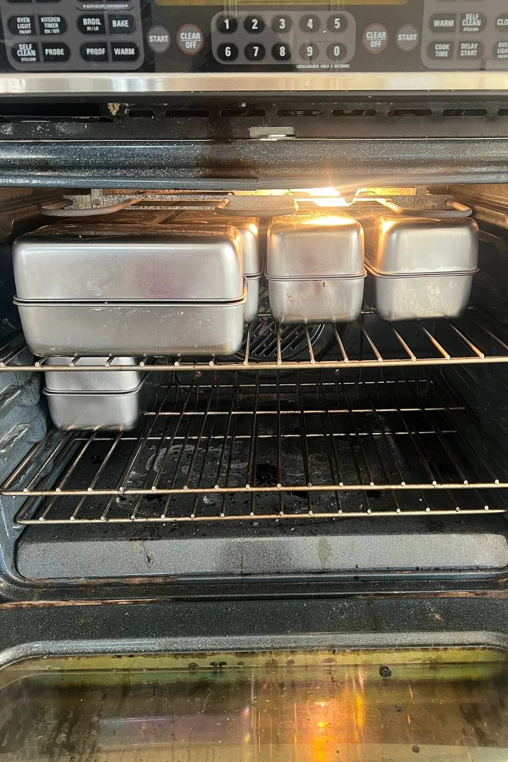 loaf pans in an oven showing how to arrange them to fit up to 12 at once
