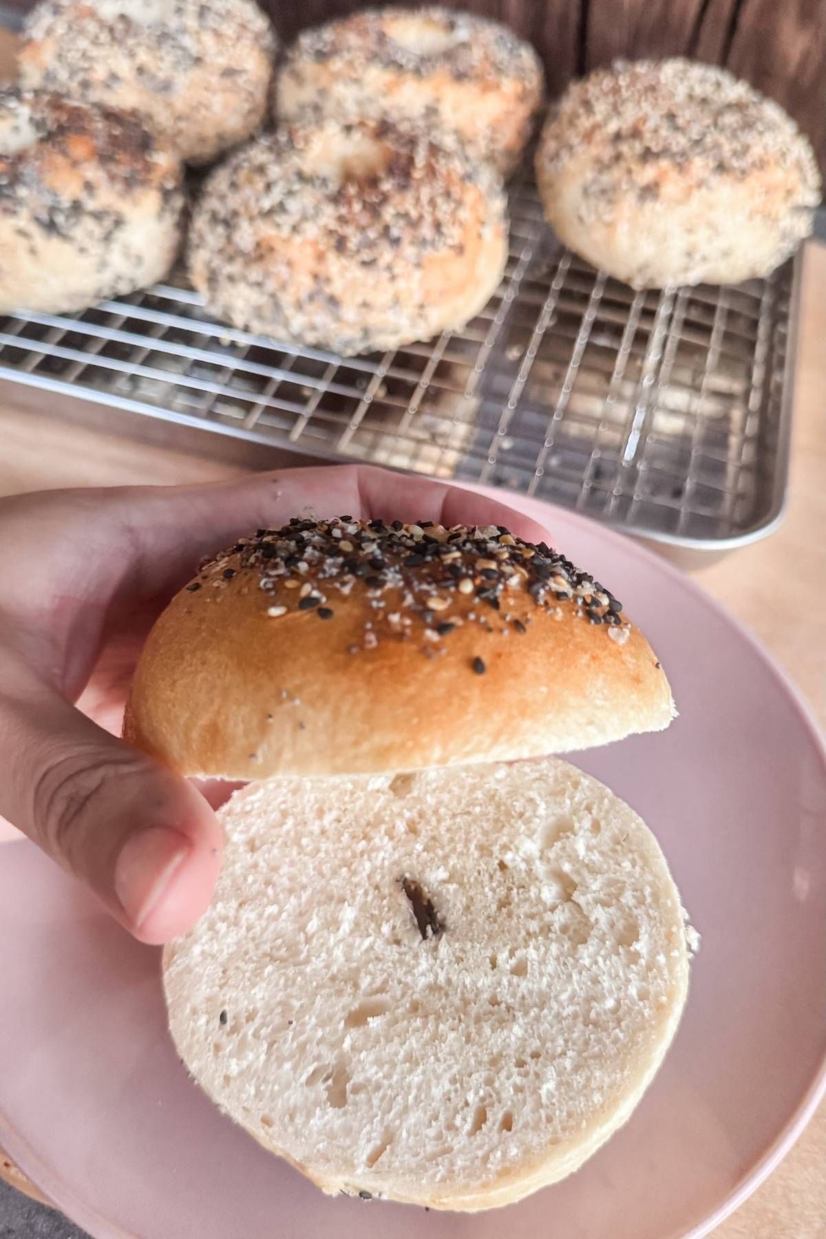 Everything bagel on a plate split in half