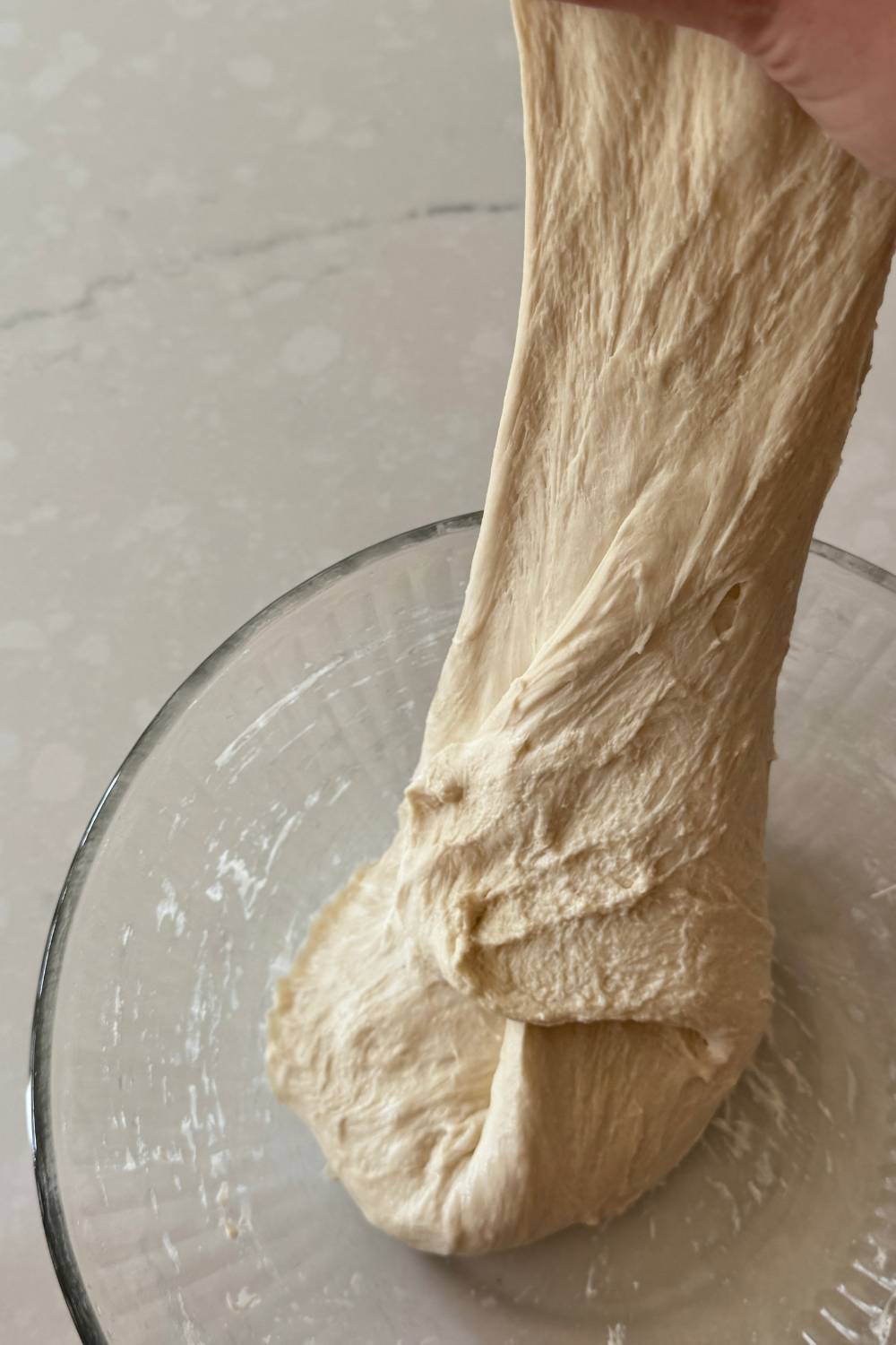 stretching pizza dough once more