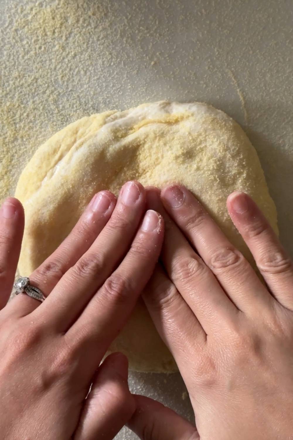 shaping sourdough pizza dough using fingers