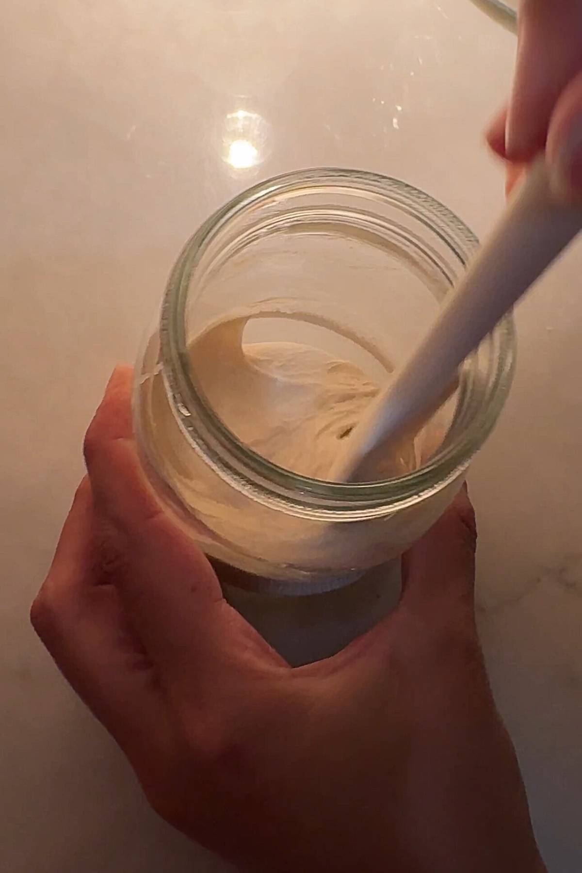 Stirring a new sourdough starter
