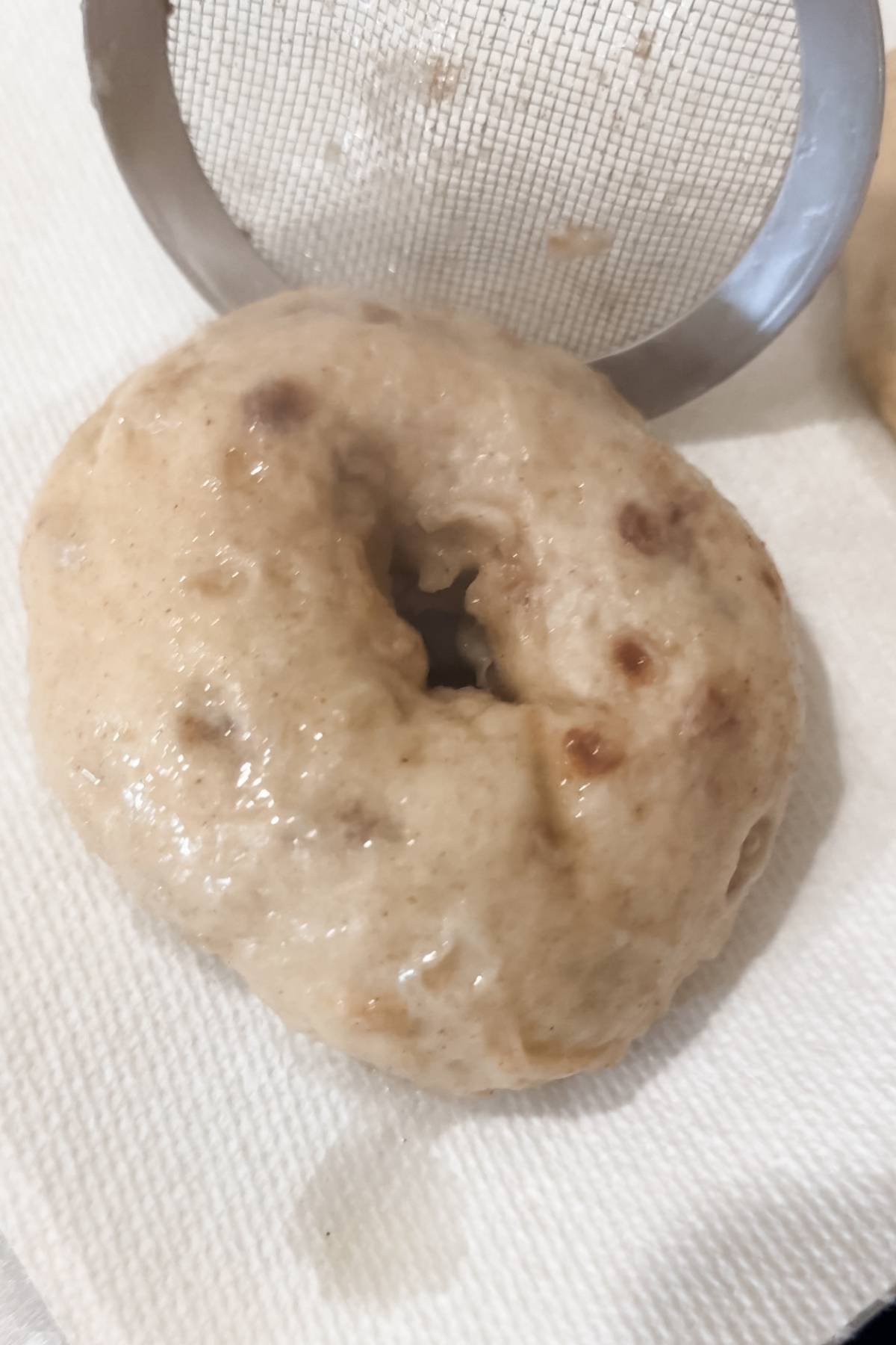 boiled Cinnamon Sugar Bagel on a baking sheet