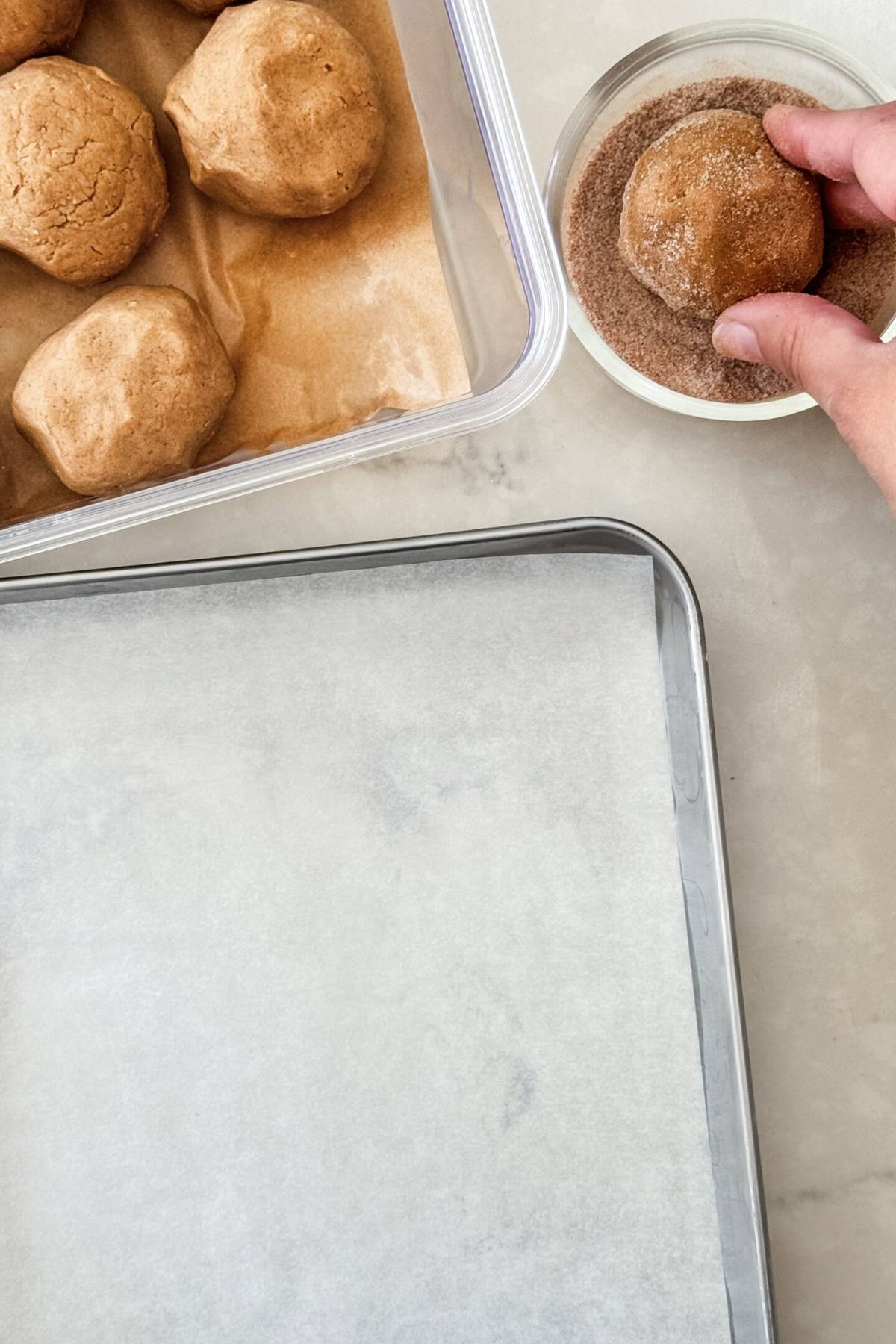 rolling snickerdoodle cookie dough on cinnamon sugar