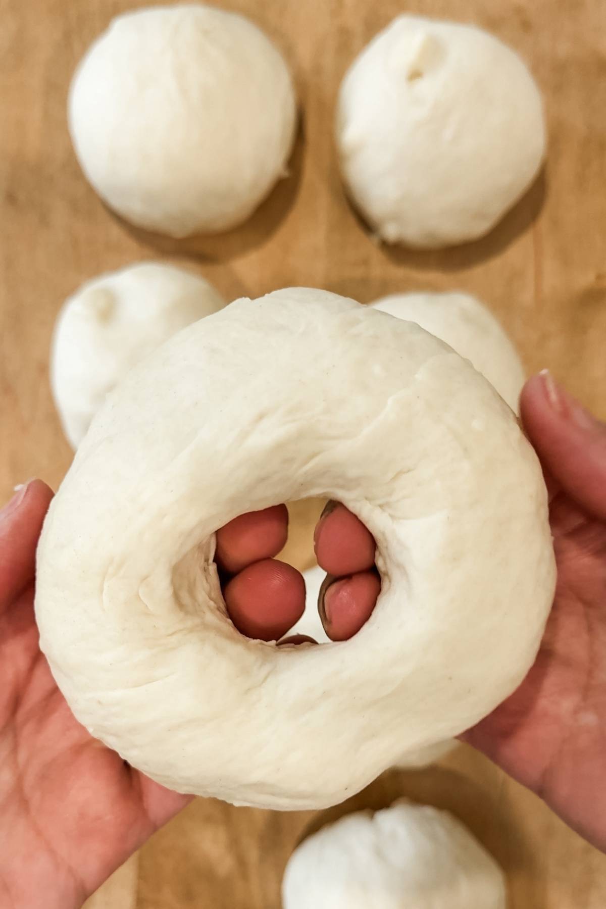 shaping the homemade asiago bagel balls into rings