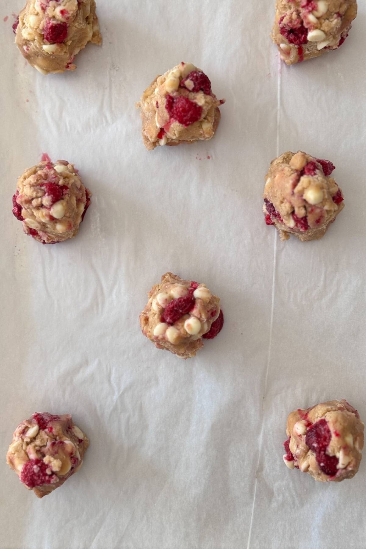 white chocolate raspberry cookie dough on a baking sheet