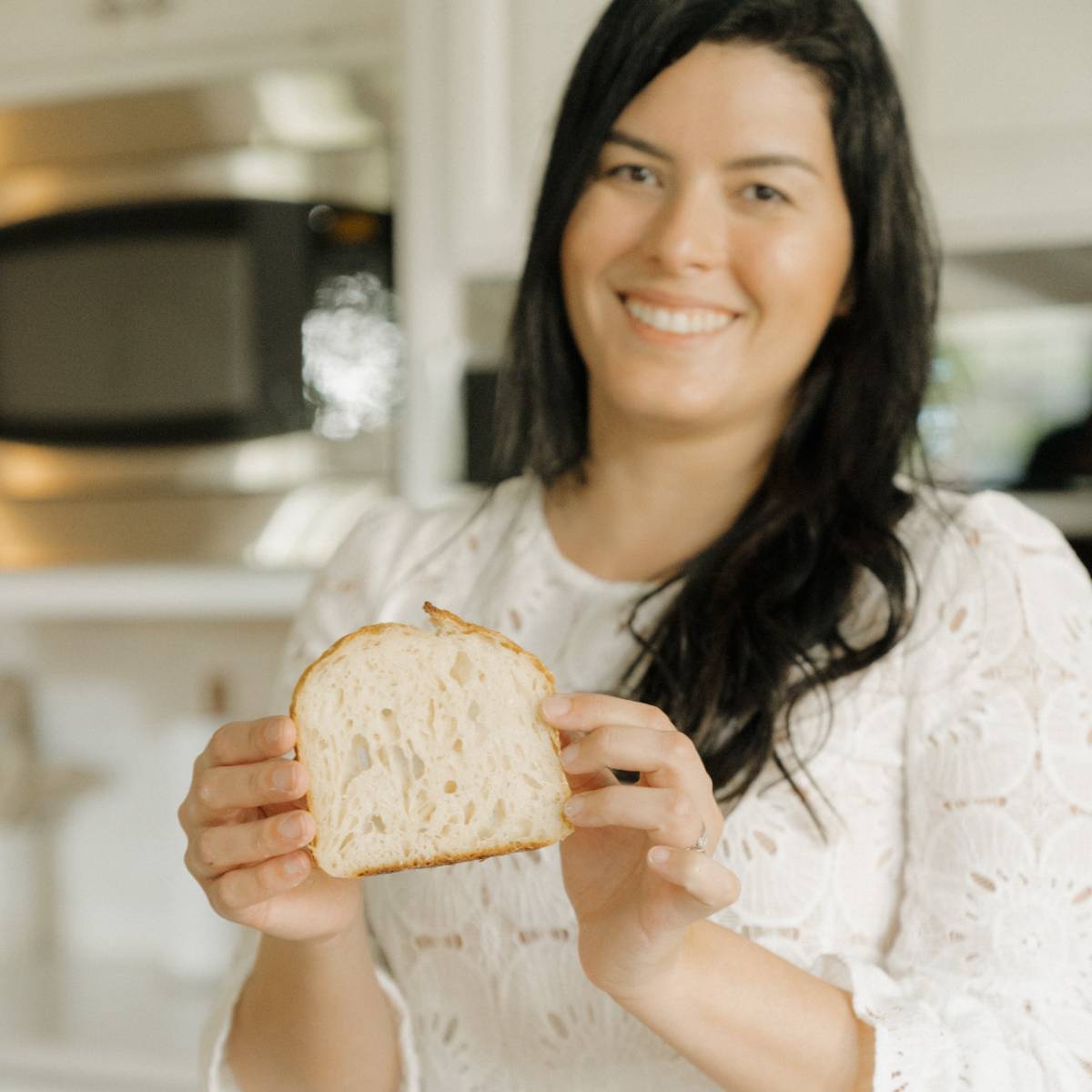 maria baradell showing a slice of her bread