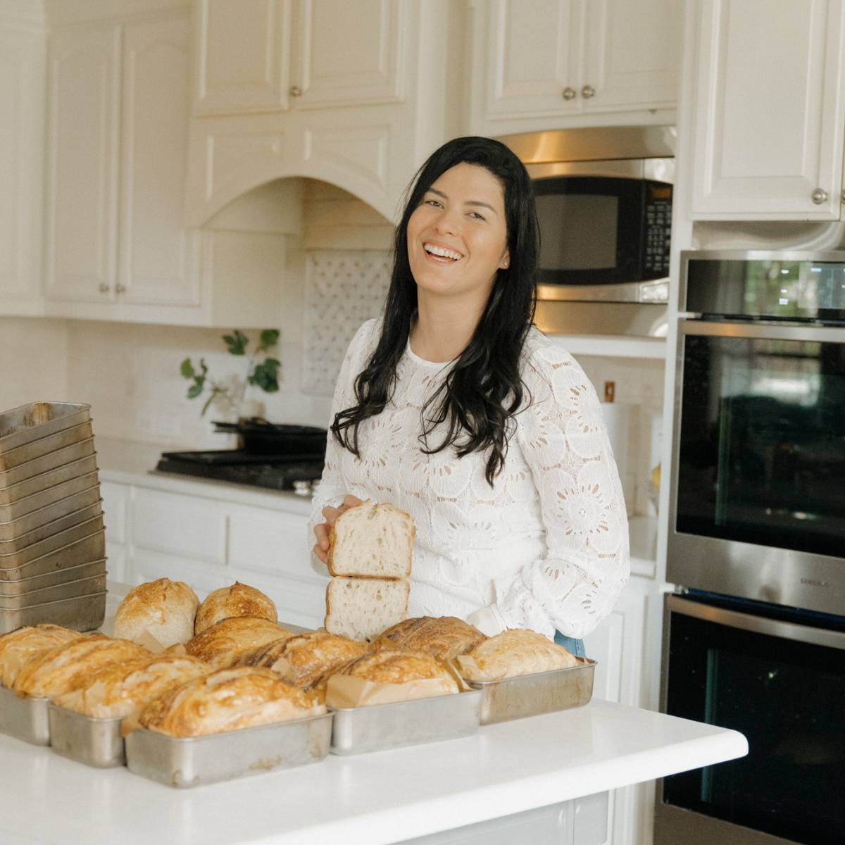 Maria Baradell showing the crumb of her loaf of sourdough bread baked using her viral two pan method