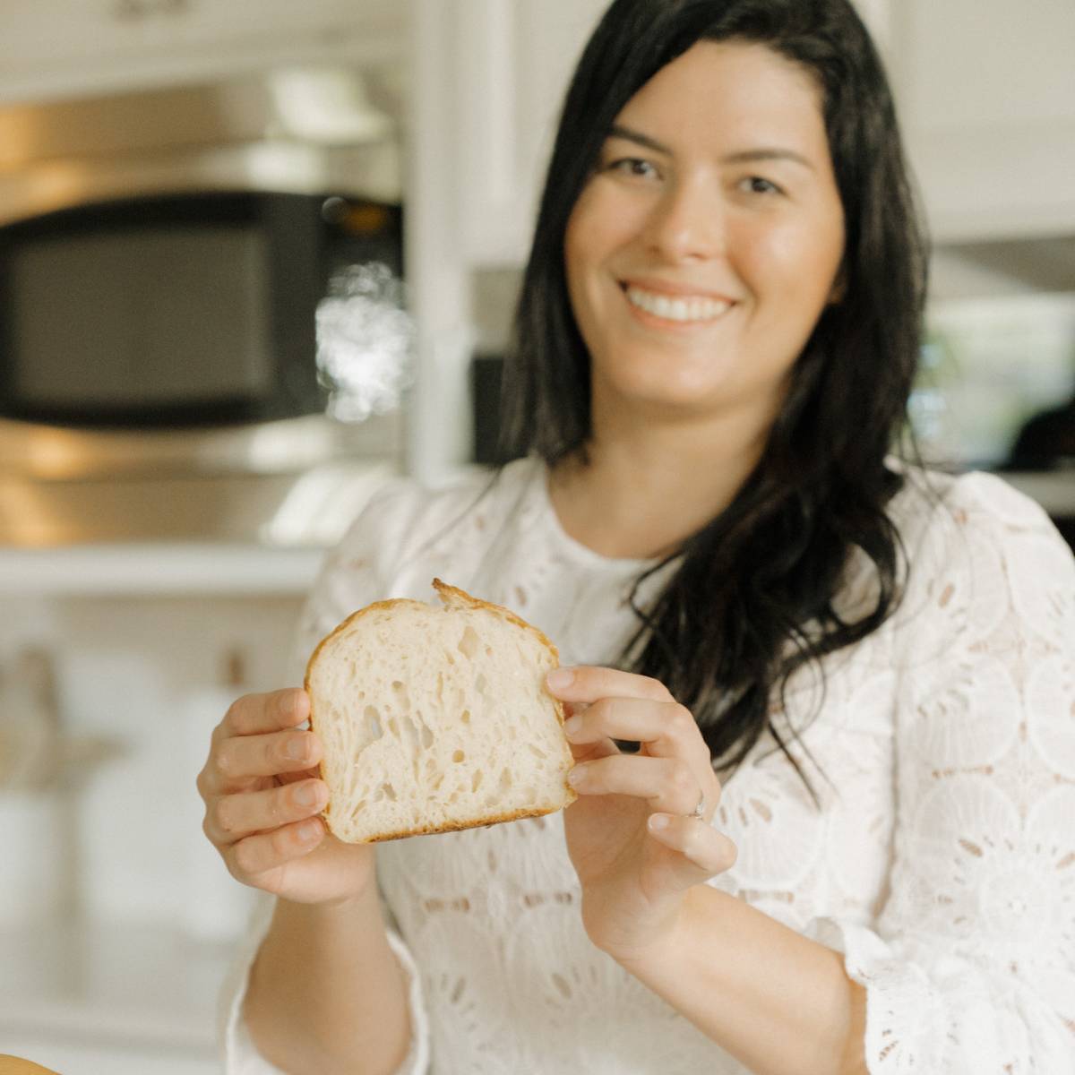 Maria Baradell showing a slice of her sourdough bread