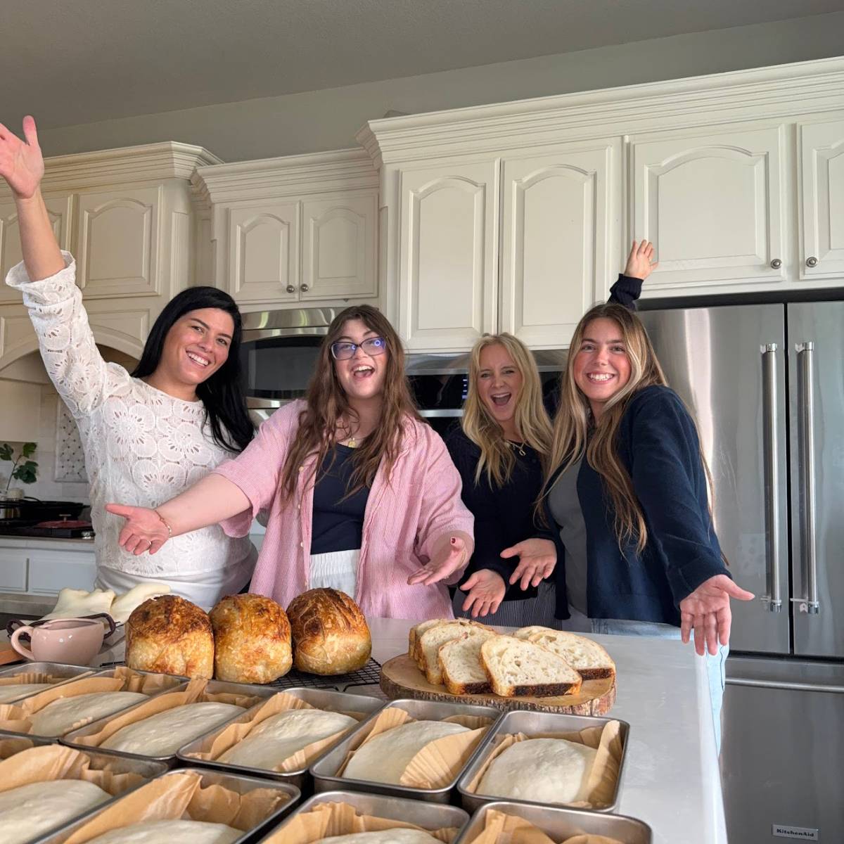 Maria and team with sourdough bread in loaf pans