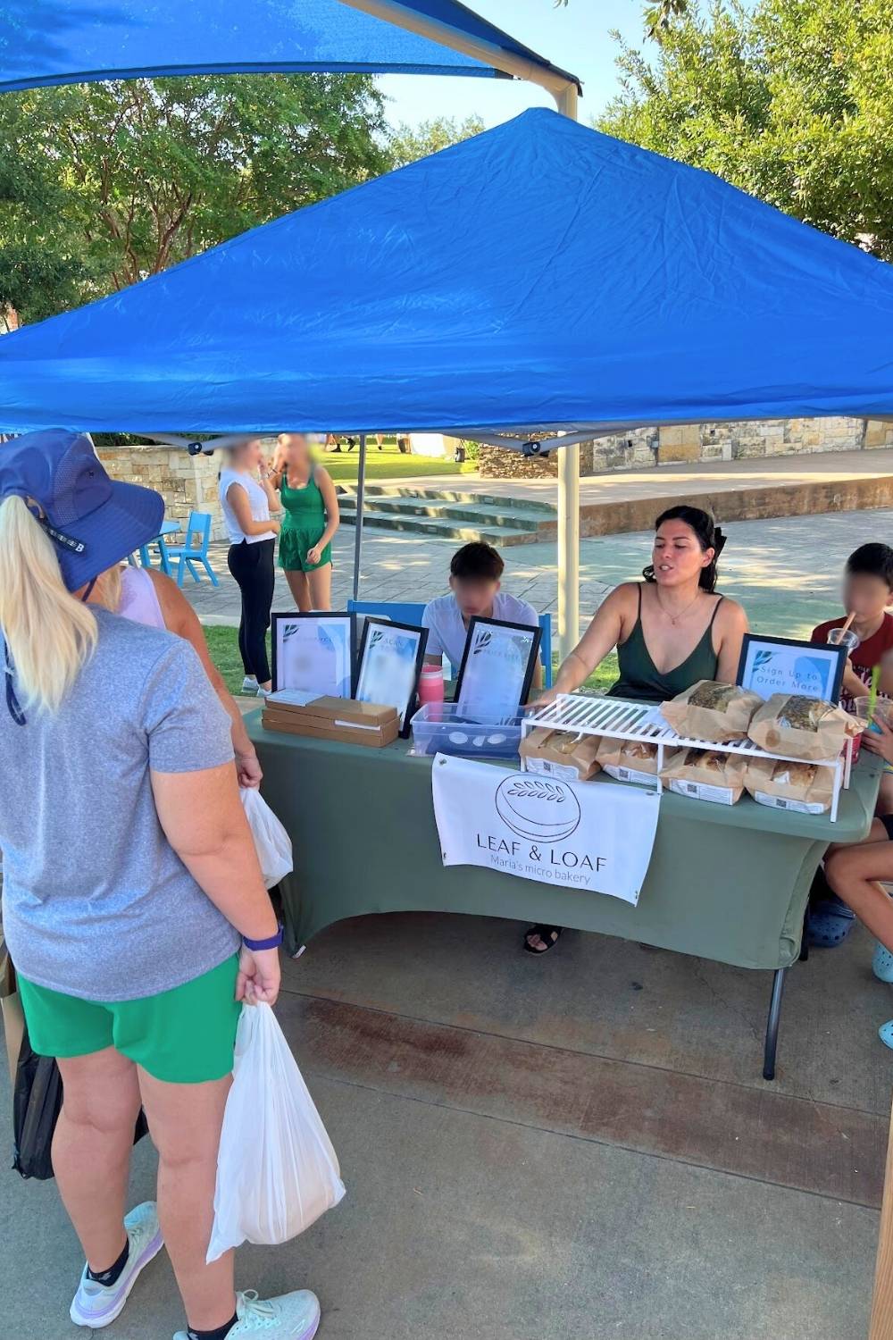 maria at the farmers market with her family and customers