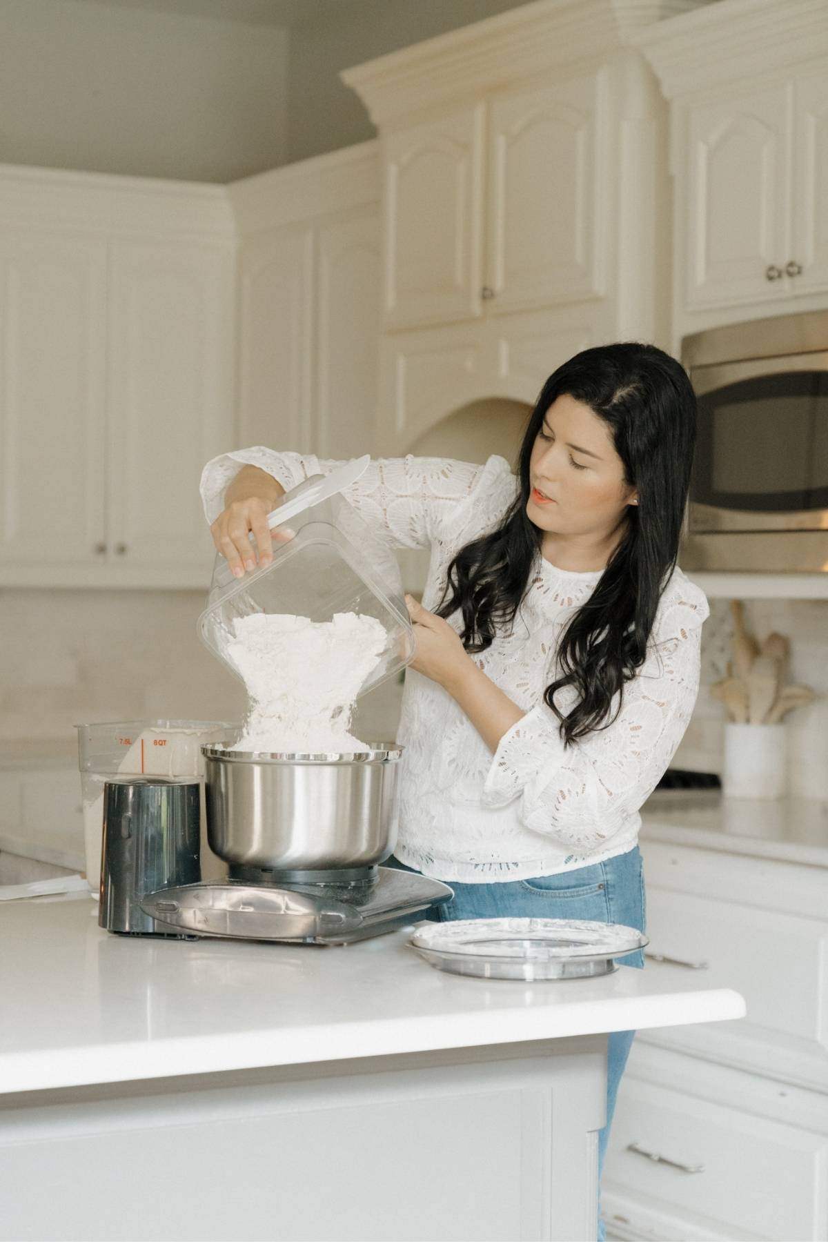 Maria adding flour to mixer