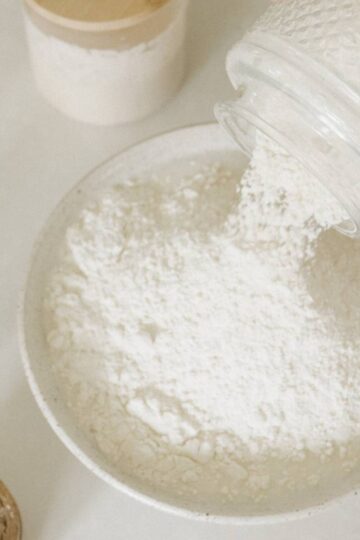 adding flour to a bowl