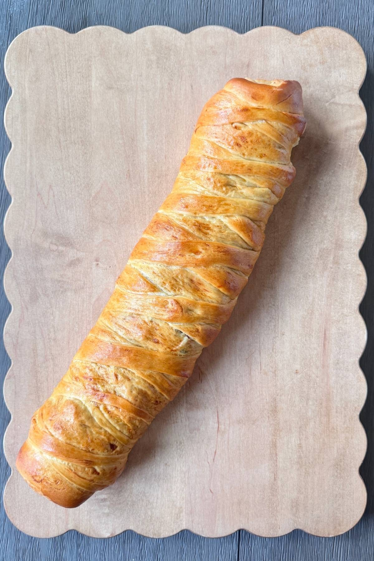 Sourdough Discard Pan de Jamon whole on a cutting board