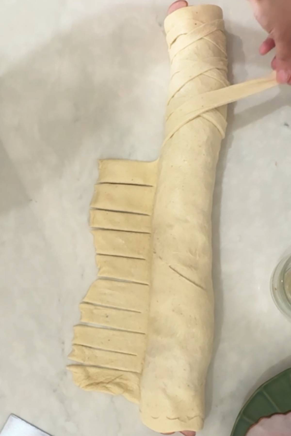 roll and decorate the dough with strips of dough