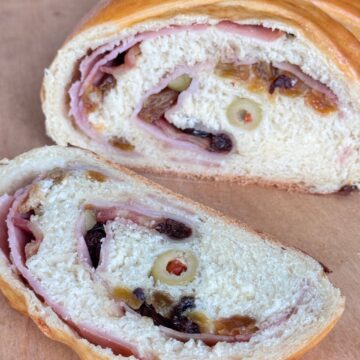 Sourdough Discard Pan de Jamon sliced on a cutting board