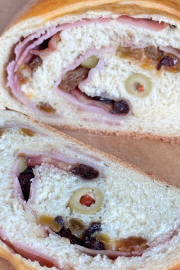 Sourdough Discard Pan de Jamon sliced on a cutting board