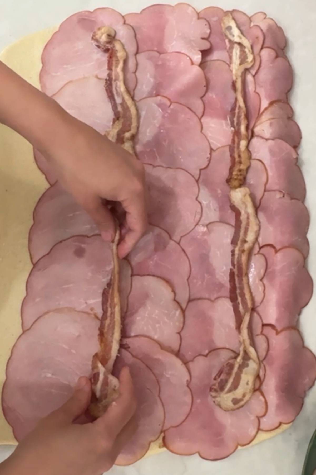 layer the ham and bacon on top of the dough