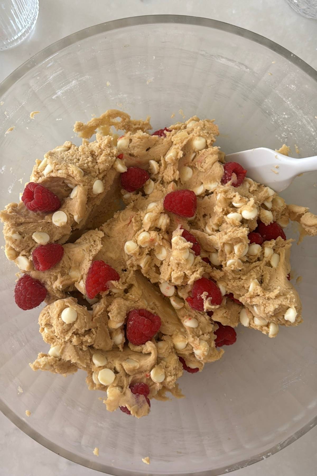 folding in the white chocolate chips and the frozen raspberries