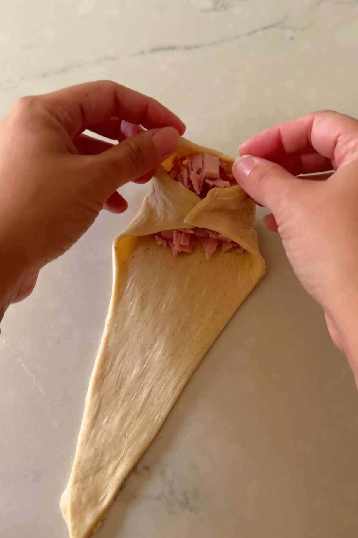 starting to roll Cachitos de Jamon - Harm Horns